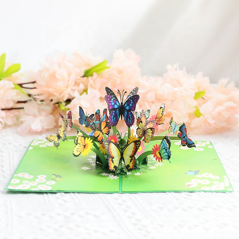 "3D popup-kort prytt med färgglada fjärilar och blommor, perfekt vårpresent i högkvalitativt färgkortspapper."