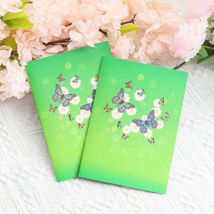 "3D popup-kort prytt med färgglada fjärilar och blommor, perfekt vårpresent i högkvalitativt färgkortspapper."