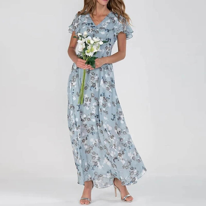 Lång sommarklänning med blommigt mönster och smickrande passform