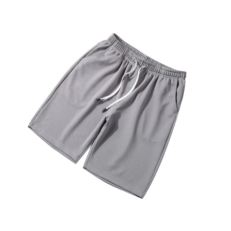 Andningsbara blå herrshorts i polyester med elastiskt midjeband, idealiska för gym och vardag.