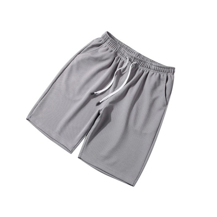Andningsbara blå herrshorts i polyester med elastiskt midjeband, idealiska för gym och vardag.