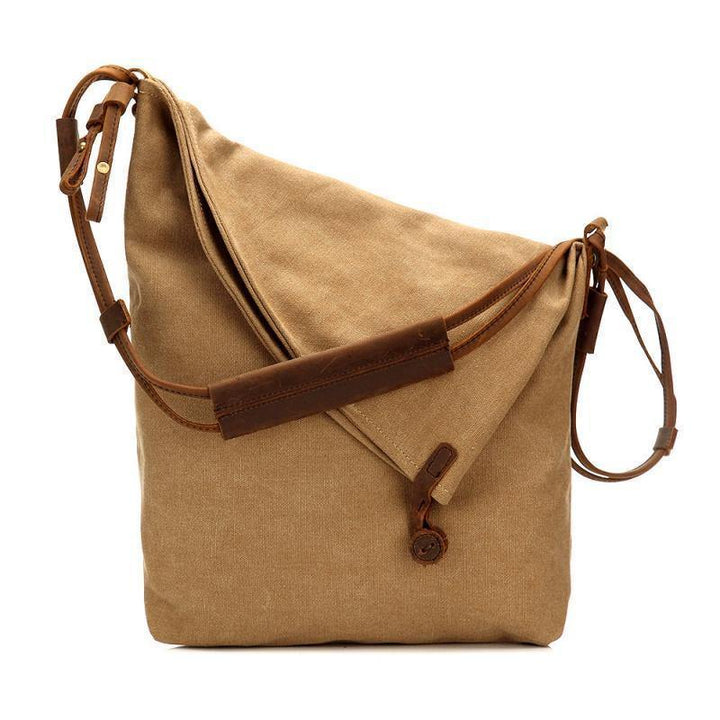 "Bohemisk crossbody-väska i beige canvas och läder, handväska för kvinnor med stilren och praktisk design."