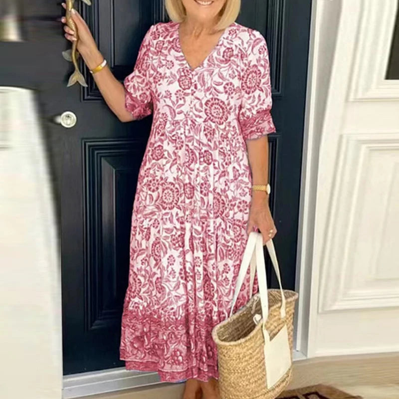 "Bohemisk dam maxiklänning med V-ringning och färgstarka blommönster, elegant fall och elastisk midja för en boho-look."