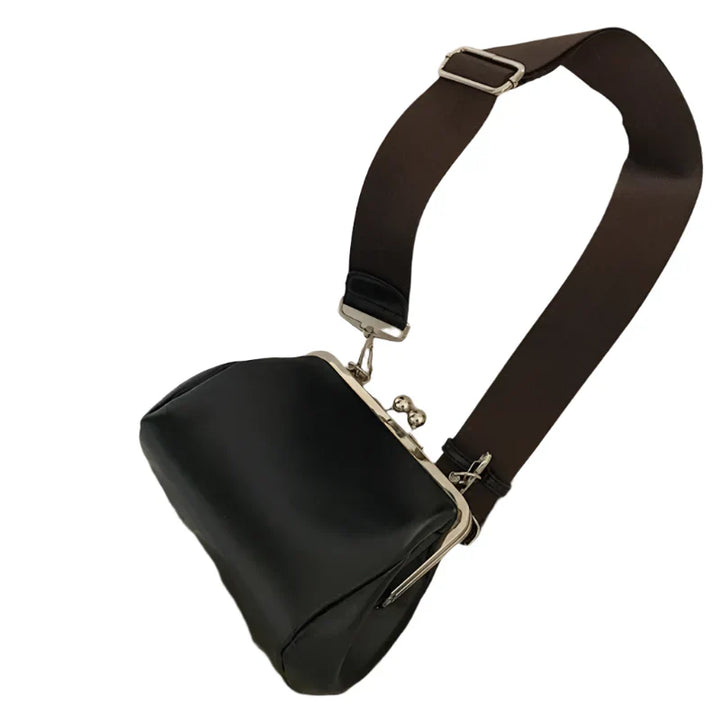 "Dam crossbody väska i PU-läder, elegant och kompakt med läpplåsstängning, perfekt för både vardag och fest."