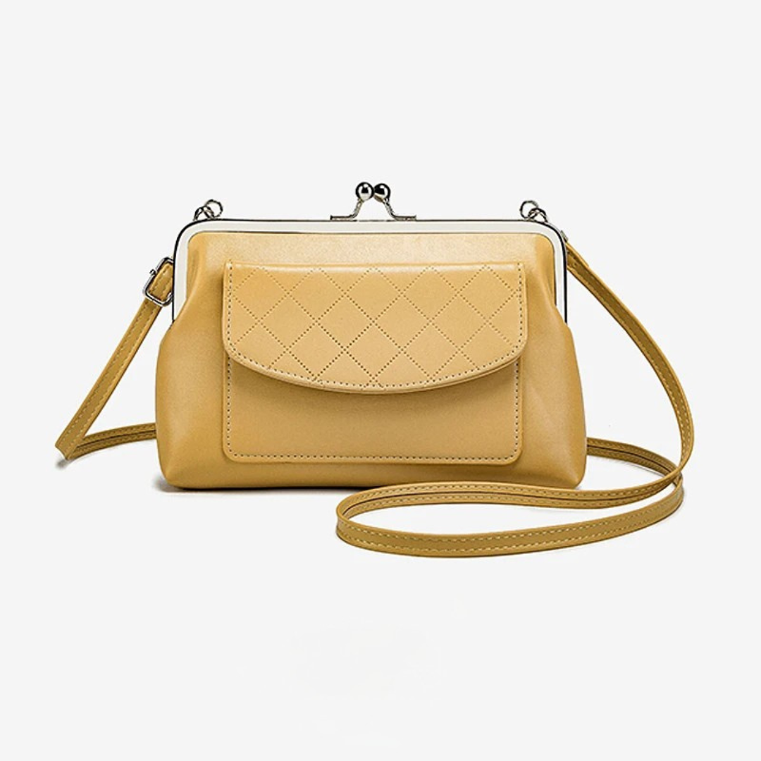 "Dam crossbody väska med läppformad stängning i svart och gul, kompakt design i konstläder, perfekt för stil och funktion."