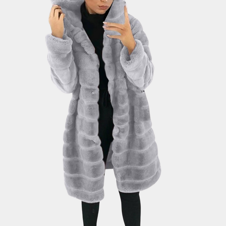 "Dam fleecejacka med huva, elegant och funktionell, perfekt för kalla dagar med stil och komfort."