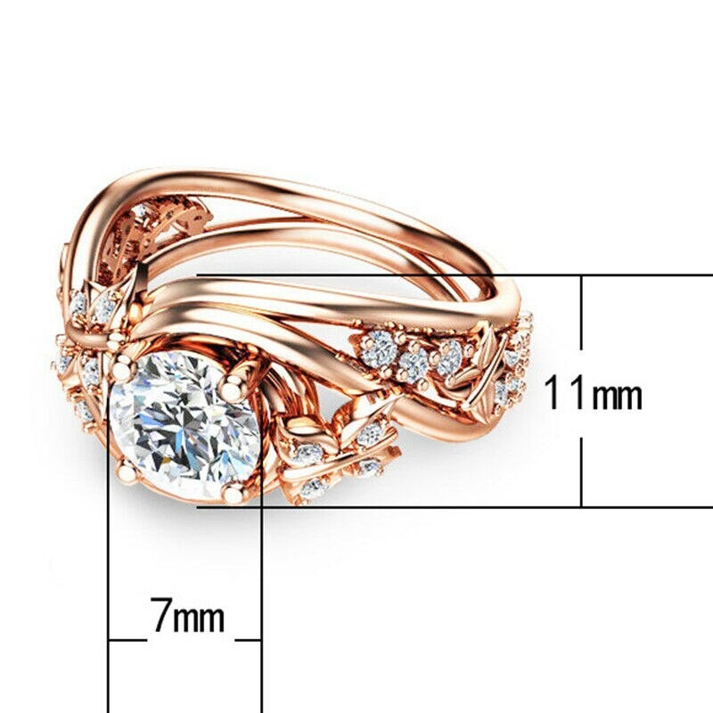 "Damer fingerring med rhinestones, fjäril och blomma i roséguld, sett framifrån."