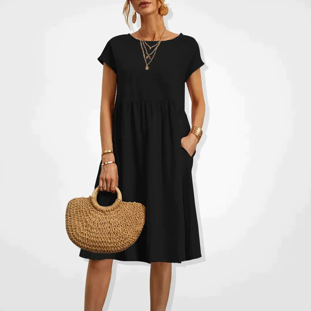 "Damernas Empire sommarklänning i lätt material med smickrande silhuett, elegant för både stranddagar och kvällsfester."