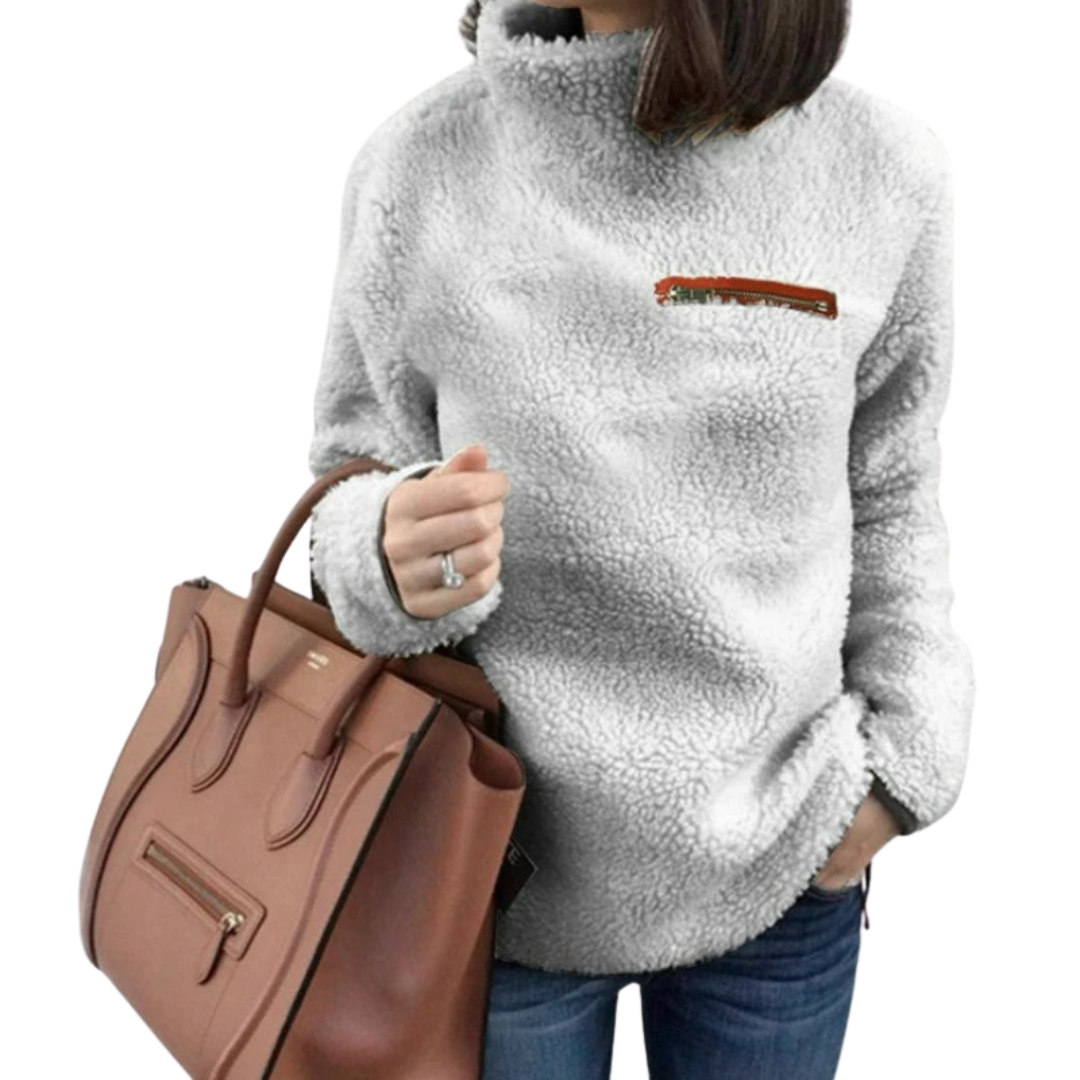 "Damtopp med sköldpaddshals i supermjukt tyg, neutral färg, stilren design. Perfekt för jeans eller leggings."