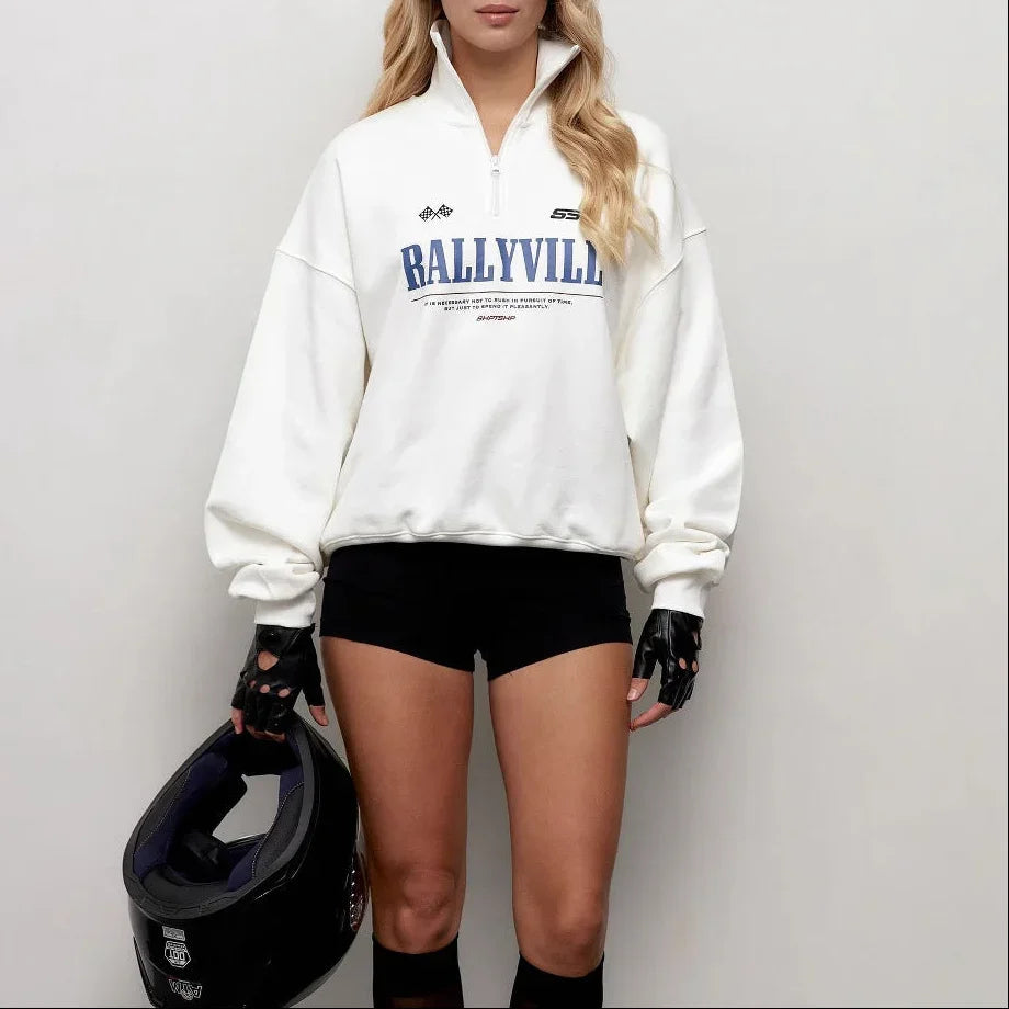 "Damtroja oversized med halv dragkedja och chic polokrage, grafiskt tryck för modern look."