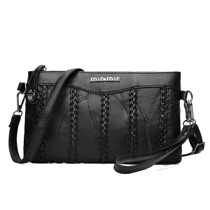 "Elegant crossbody clutch väska i svart PU-läder för kvinnor, med modern design och plats för nödvändigheter."
