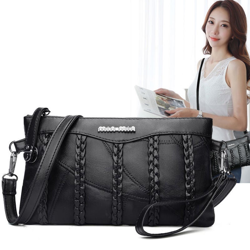 "Elegant crossbody clutch väska i svart PU-läder för kvinnor, med modern design och plats för nödvändigheter."
