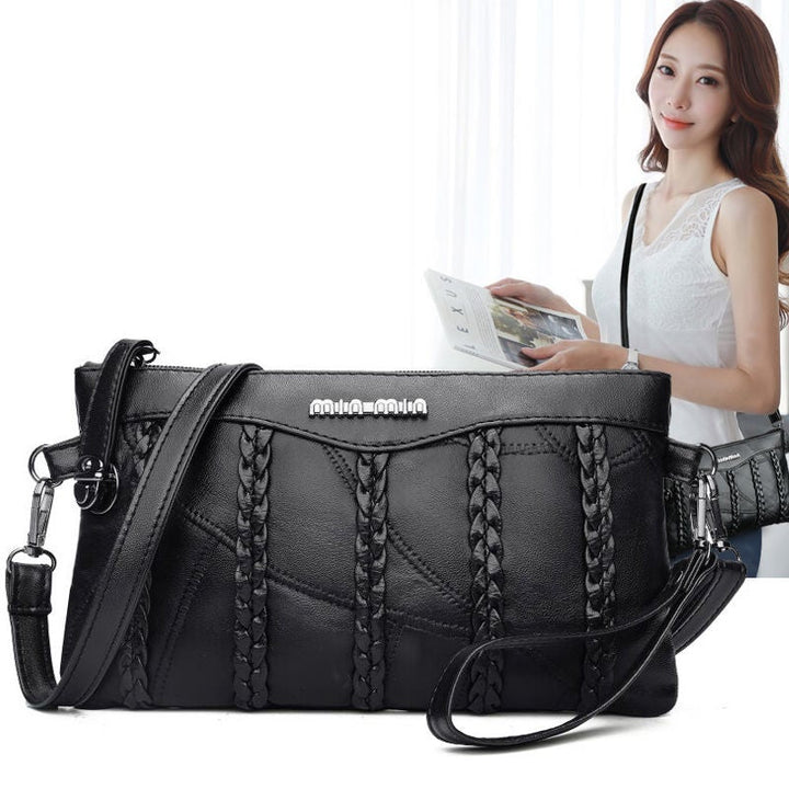 "Elegant crossbody clutch väska i svart PU-läder för kvinnor, med modern design och plats för nödvändigheter."