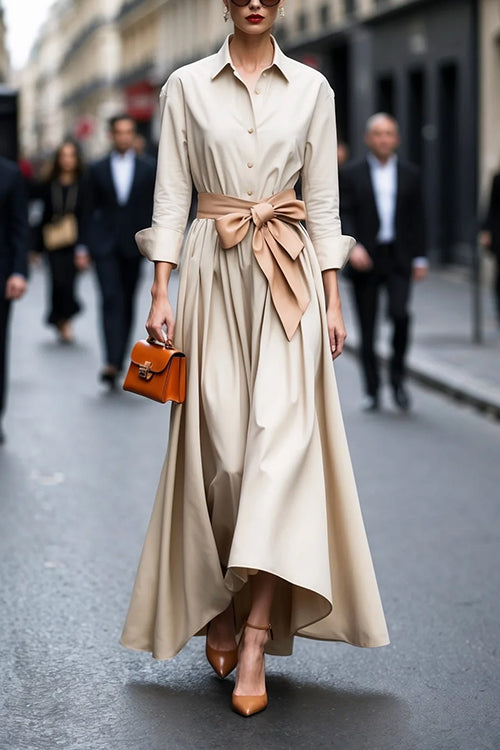 "Elegant dam maxiklänning med knappar och knytband, långärmad i beige, lila, och mörkblå färg, perfekt för alla tillfällen."
