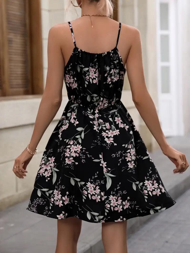 "Elegant dam sommarklänning med blommigt tryck, spaghettiband, knälång, lätt polyester för luftigt sommarbruk."