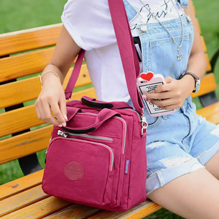"Elegant dam vattenavvisande crossbodyväska i nylon med justerbar axelrem och flera fickor för stil och funktion."