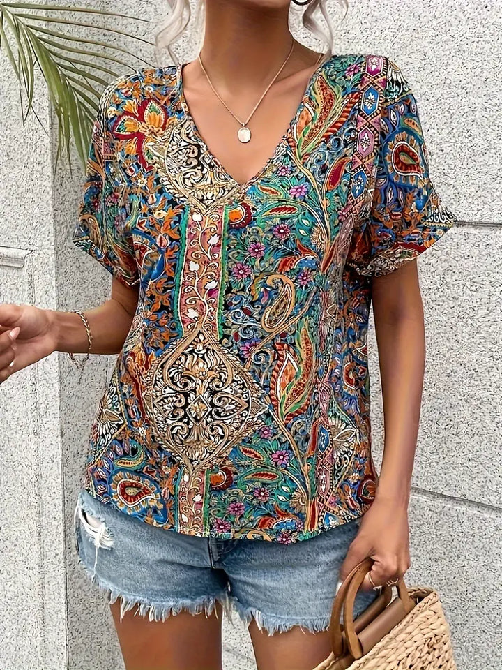 "Elegant damblus med V-ringning och färgglatt paisley-mönster, perfekt för både formella och avslappnade tillfällen."