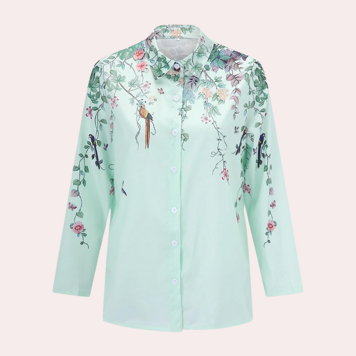 "Elegant damblus med blommiga broderier, puffärmar och luftigt tyg för romantisk och klassisk stil."