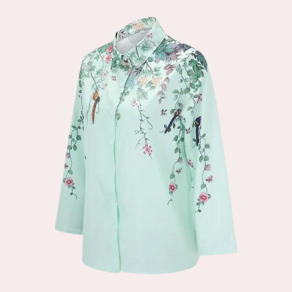 "Elegant damblus med blommiga broderier, puffärmar och luftigt tyg för romantisk och klassisk stil."