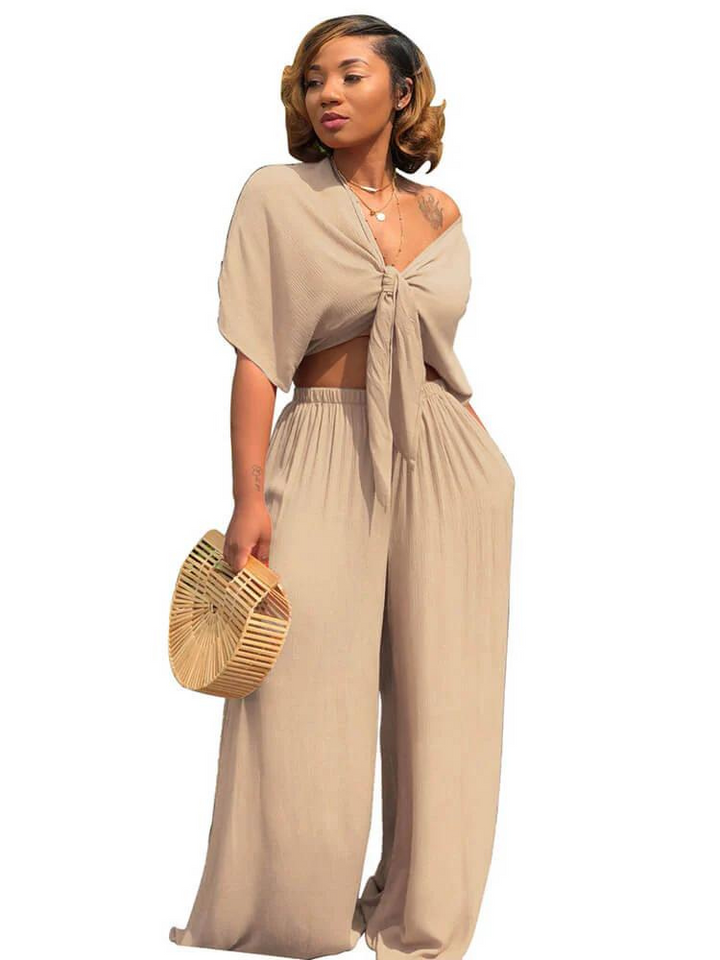 "Elegant damdressat set med crop top och vida raka byxor, skapar en stilren och självsäker look för moderna kvinnor."