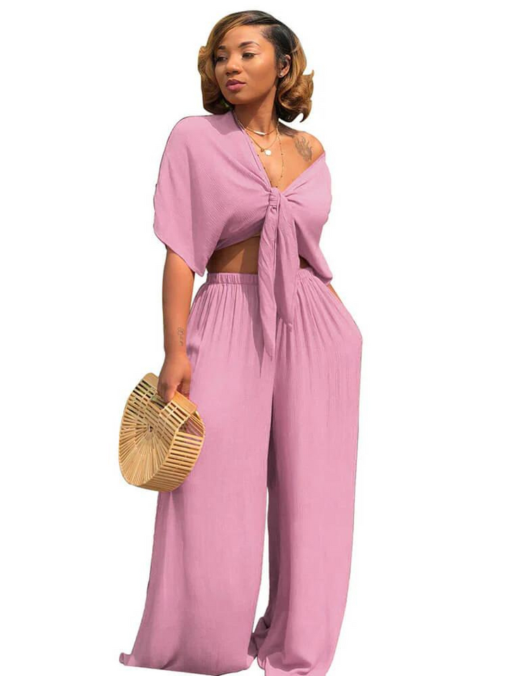 "Elegant damdressat set med crop top och vida raka byxor, skapar en stilren och självsäker look för moderna kvinnor."