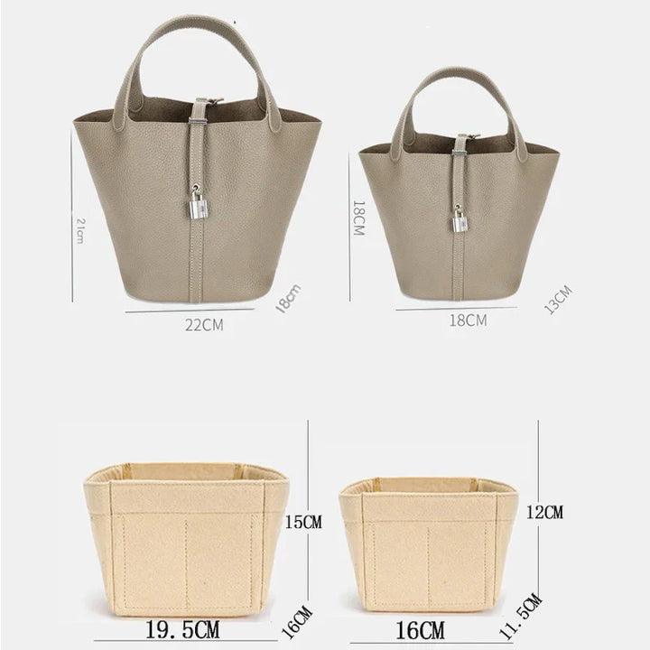 "Elegant damhandväska i beige konstläder med stor kapacitet och flertalet fack, perfekt för mode och funktionalitet."