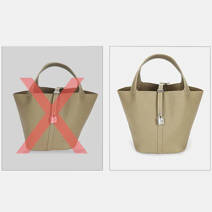 "Elegant damhandväska i beige konstläder med stor kapacitet och flertalet fack, perfekt för mode och funktionalitet."