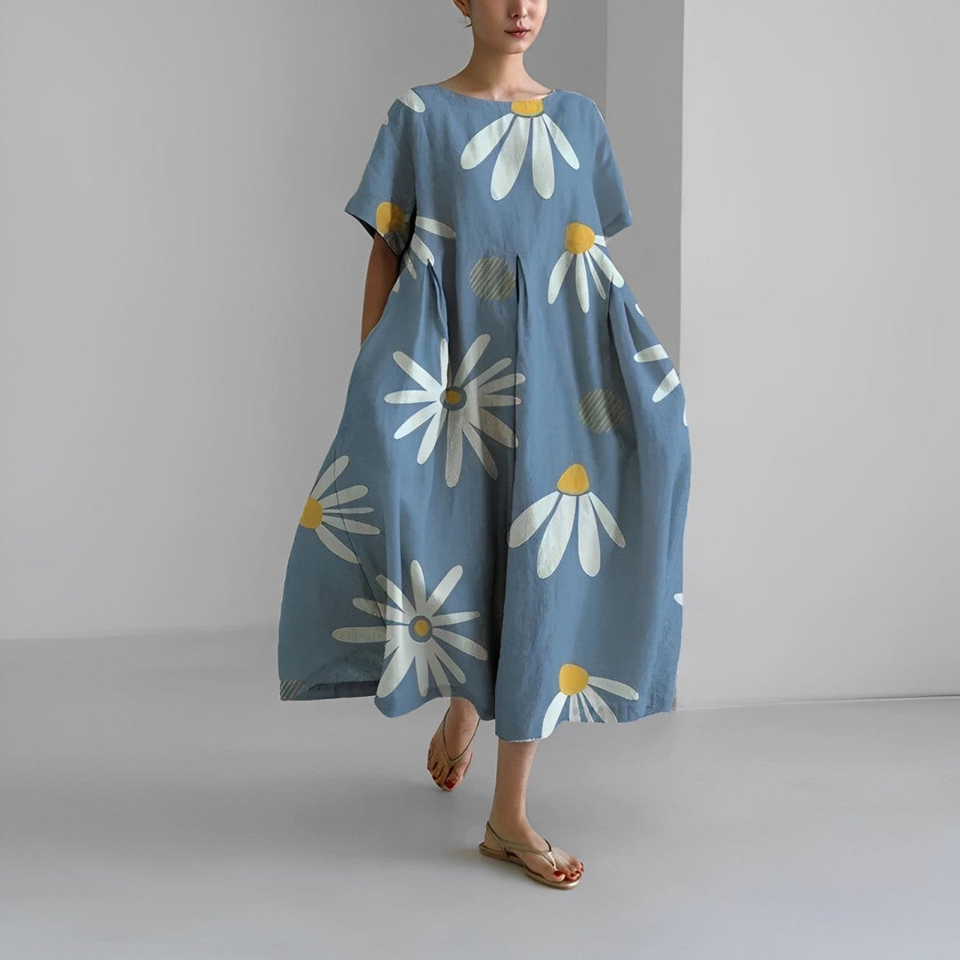 "Elegant damklänning i mjuk bomull med blommönster, figurnära passform och somrig stil, perfekt för varma dagar."