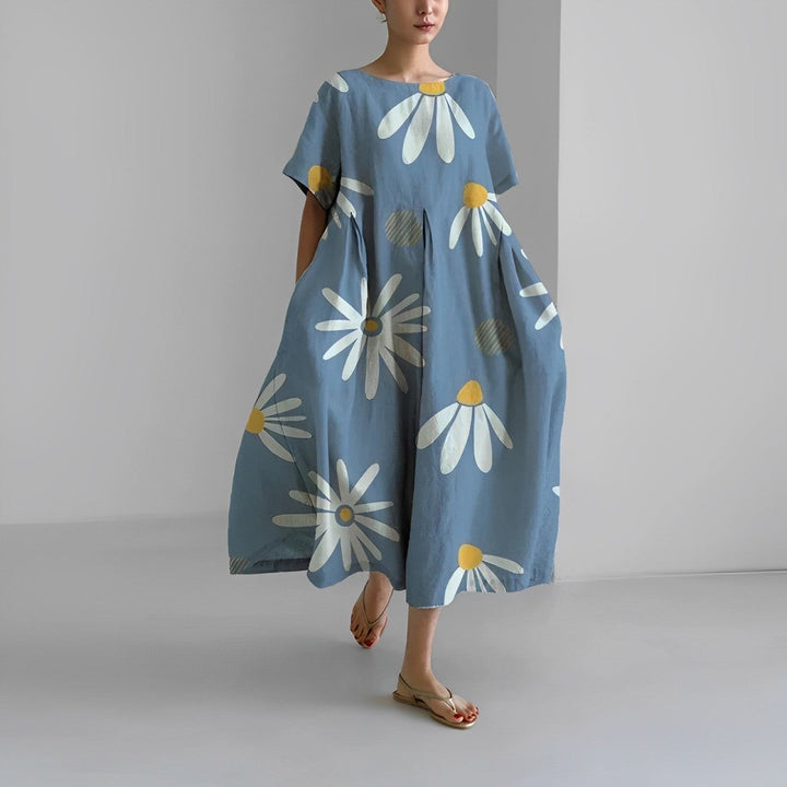 "Elegant damklänning i mjuk bomull med blommönster, figurnära passform och somrig stil, perfekt för varma dagar."