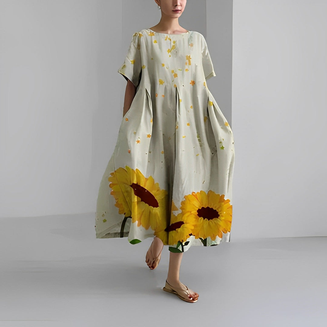 "Elegant damklänning i mjuk bomull med blommönster, figurnära passform och somrig stil, perfekt för varma dagar."