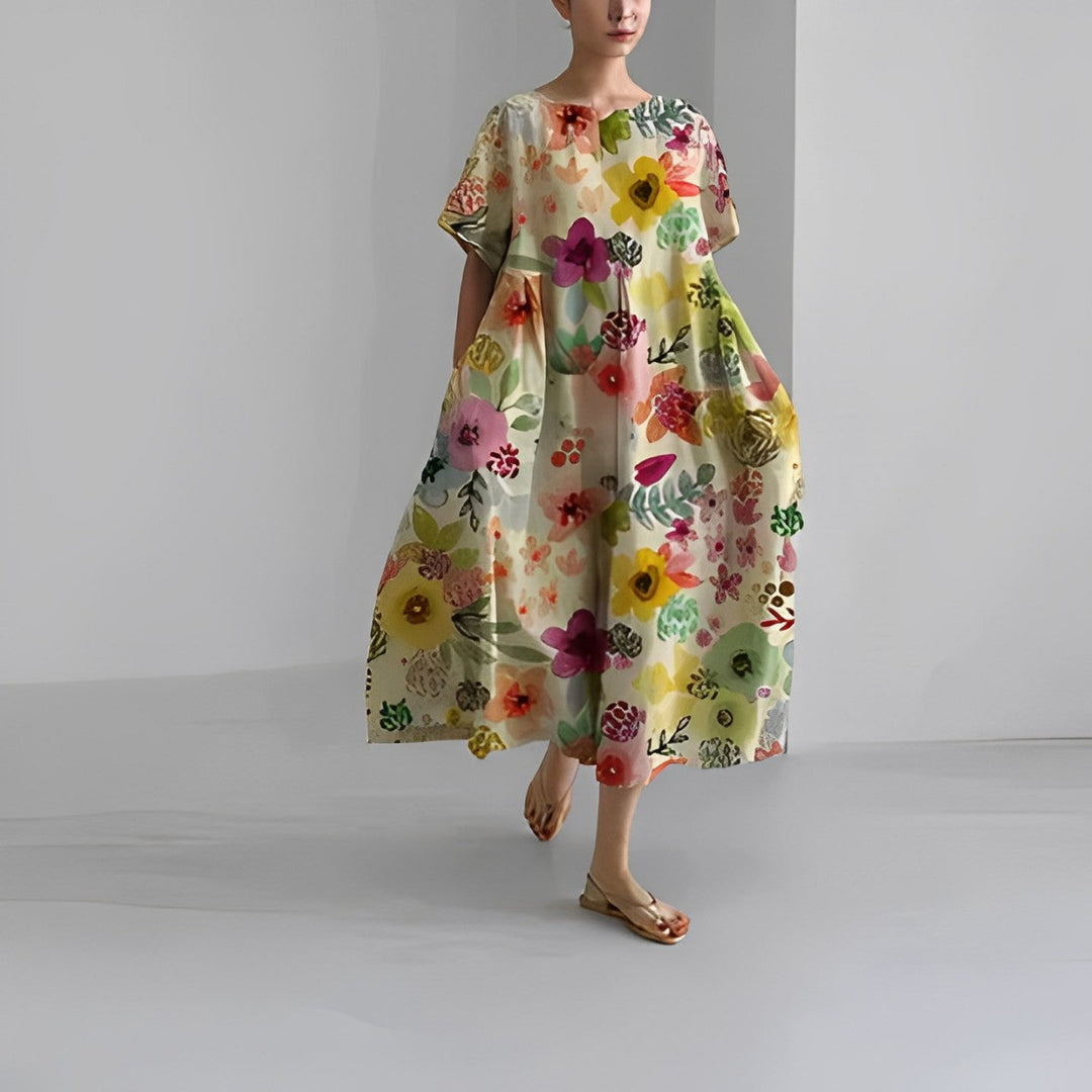 "Elegant damklänning i mjuk bomull med blommönster, figurnära passform och somrig stil, perfekt för varma dagar."