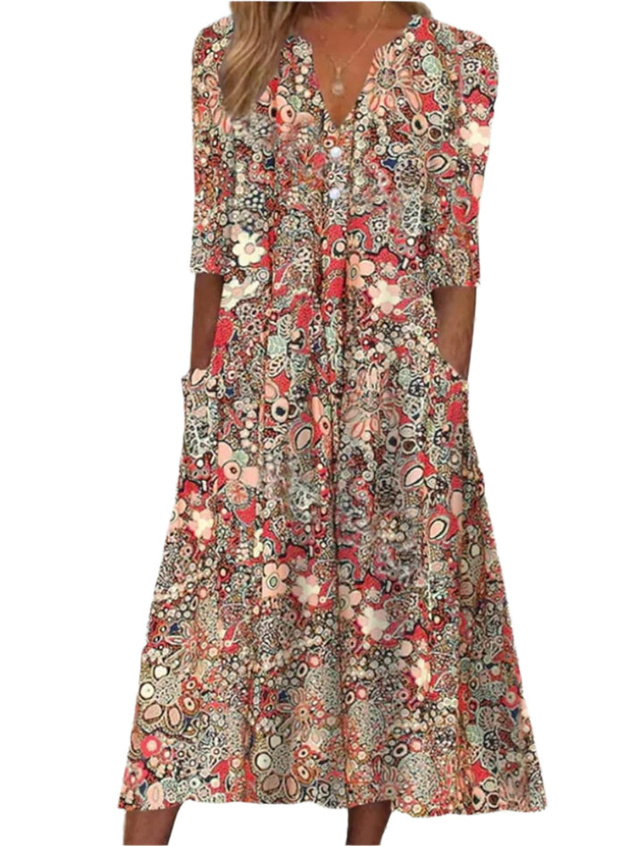 "Elegant damklänning med ljusblått blommönster, lätt material, perfekt för vår- och sommaraktiviteter."