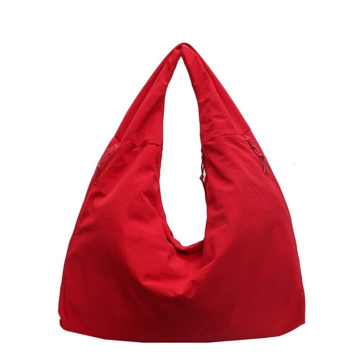 "Elegant damväska, minimalistisk design, flexibelt material, rymlig och lätt, perfekt för både arbete och fritid."