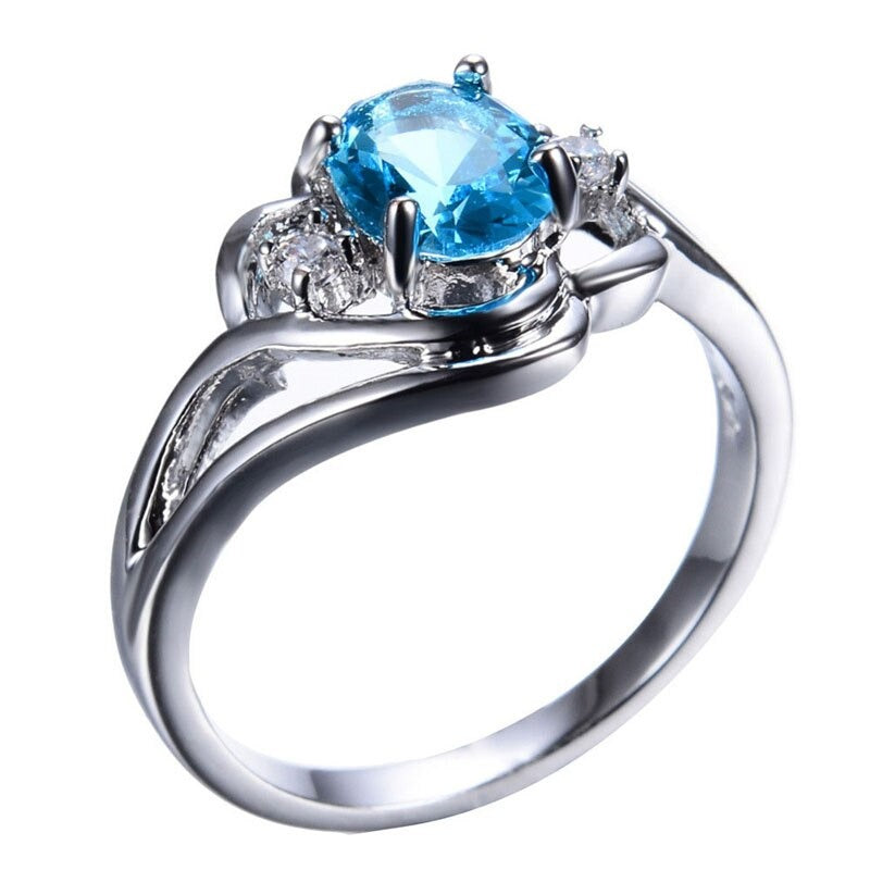 "Elegant födelsesten ring med oval sten & cubic zirconia, perfekt för kvinnor, vardag & festliga tillfällen, i blå och röd."