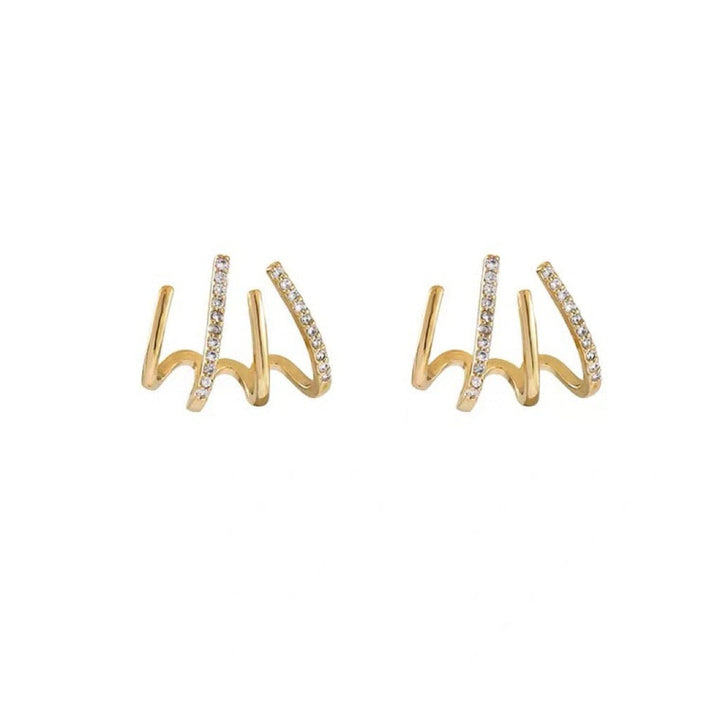 "Elegant klor örhängen med kubisk zirkonia, guldfärg, feminin design, ger illusion av flera piercingar, kvinnor."