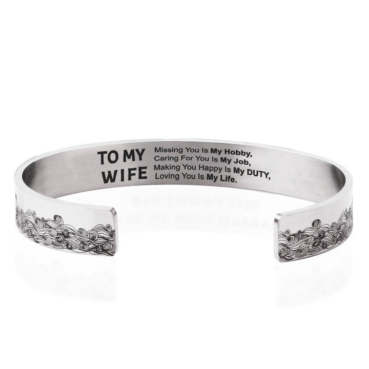 "Elegant manschettarmband av rostfritt stål för kvinnor, C-form, glansig finish, justerbar passform, stilren accessoar."