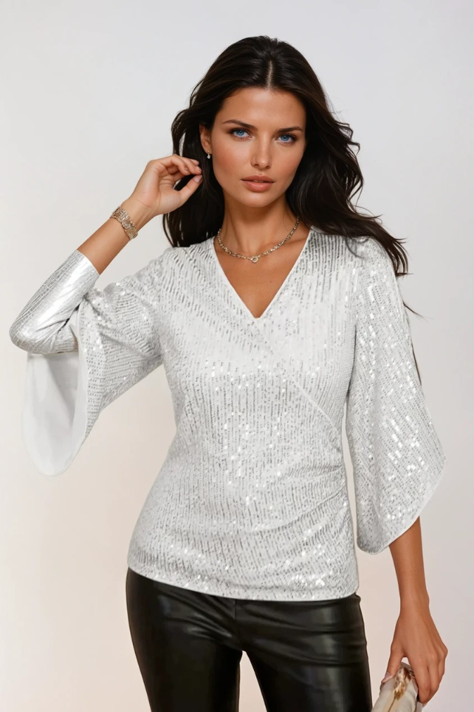 Glittrande dam wrap-blus med flödande ärmar och V-hals, perfekt för både vardag och fest.
