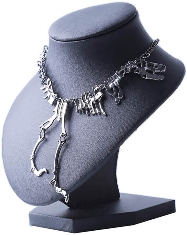 "Halsband med detaljerat T-Rex-skelett, rörlig design i brons och guld. Perfekt för damer som älskar dinosaurier."