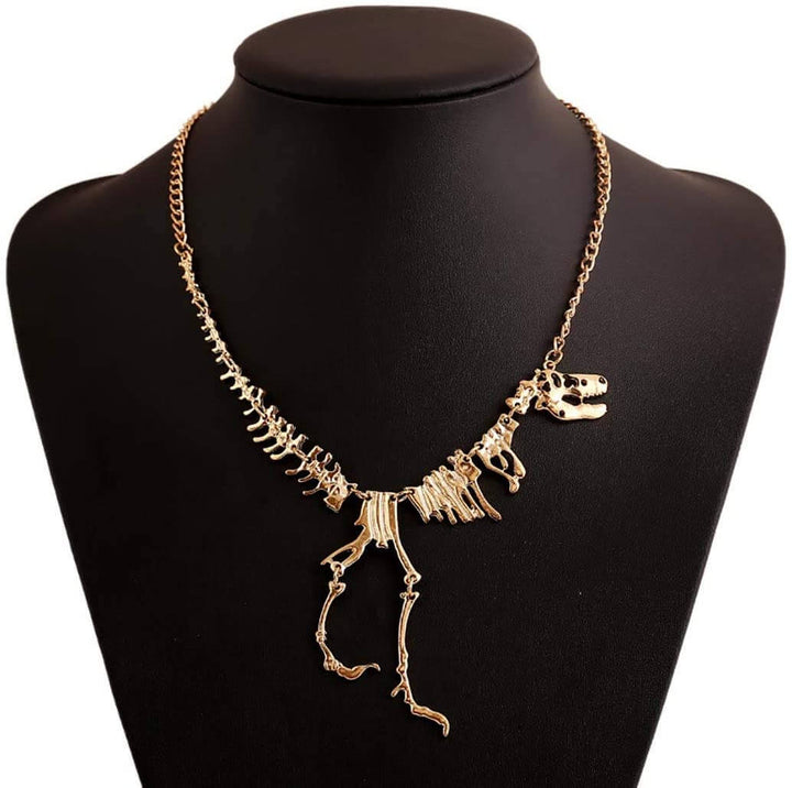 "Halsband med detaljerat T-Rex-skelett, rörlig design i brons och guld. Perfekt för damer som älskar dinosaurier."