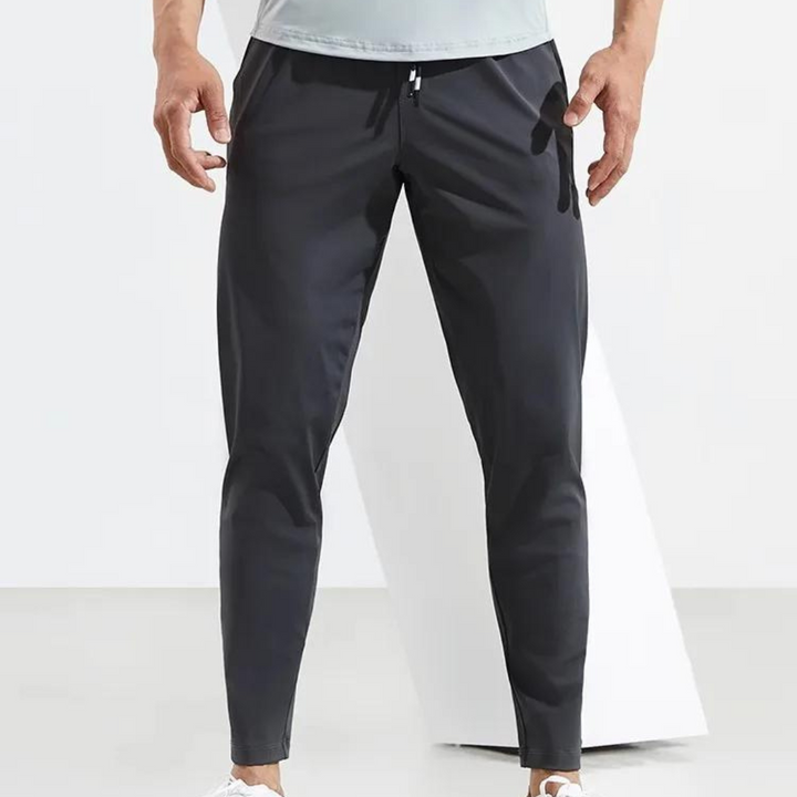 "Herr löparbyxor i snabbtorkande material, skräddarsydd passform, elegant svart design för outdoor och stadsmiljö."
