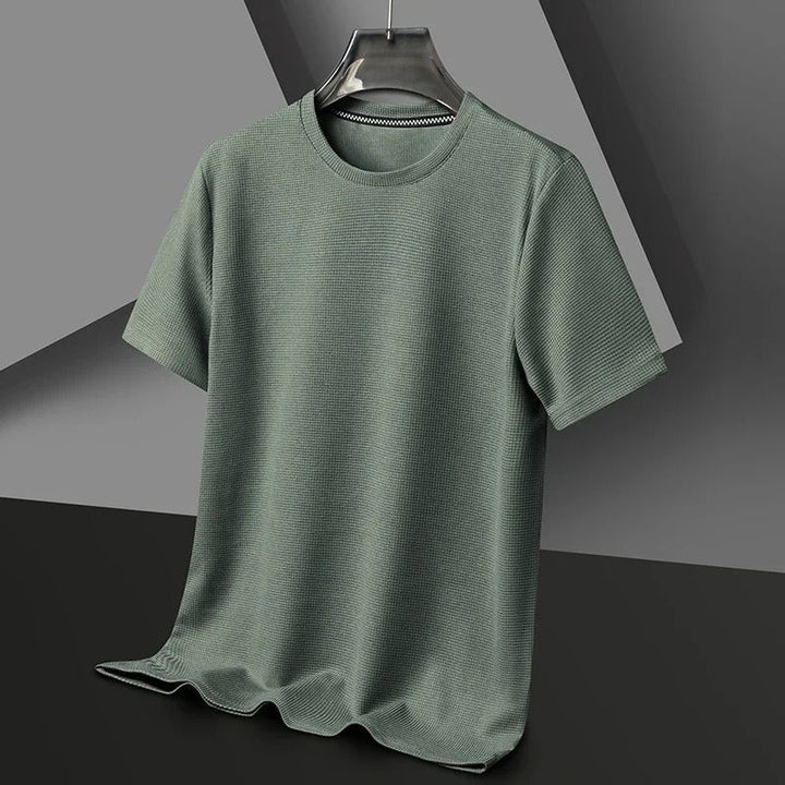 "Herr våfflad bomullst-shirt med rund hals, grön, unikt texturerat tyg, andningsbart och stilfullt, perfekt vardagsplagg."