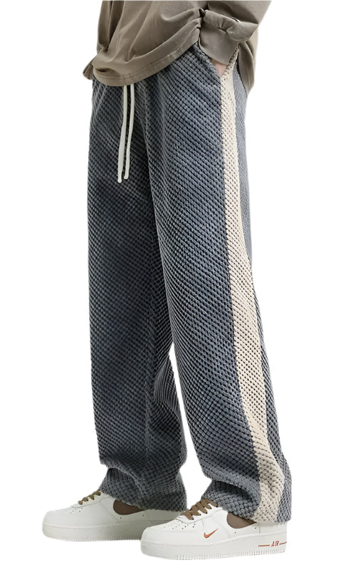 "Herrsweatpants i grå/svart corduroy med dragsko, stilren design och praktiska fickor för optimal komfort och passform."