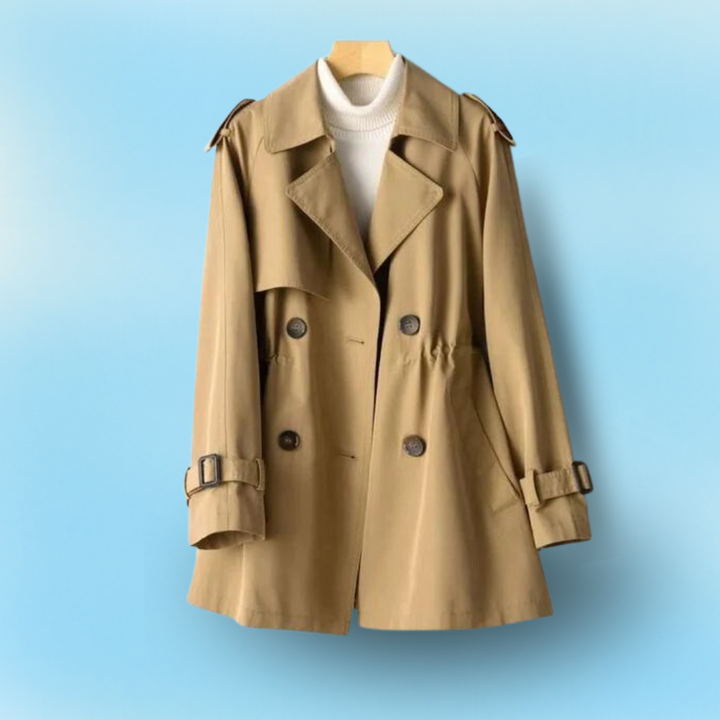 "Kvinna vintage trench coat, dubbelknäppt, nylon-bomull, elegant design, lång silhuett, klassisk look, slitstarkt material."
