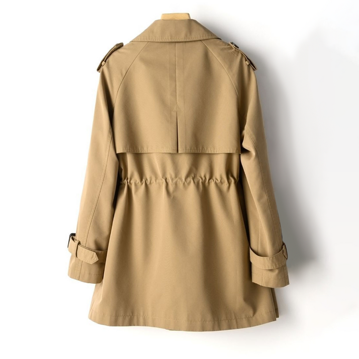 "Kvinna vintage trench coat, dubbelknäppt, nylon-bomull, elegant design, lång silhuett, klassisk look, slitstarkt material."