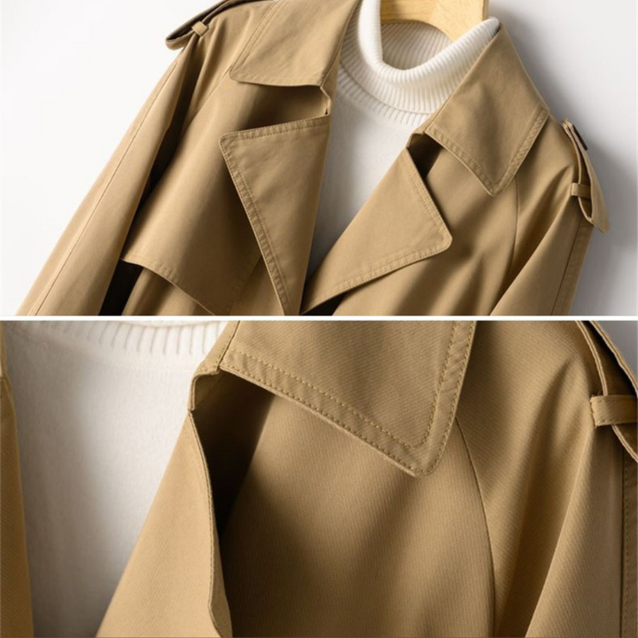 "Kvinna vintage trench coat, dubbelknäppt, nylon-bomull, elegant design, lång silhuett, klassisk look, slitstarkt material."