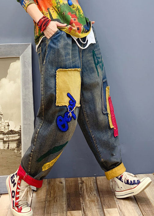 "Kvinnor denim byxor med handgjorda patchdetaljer, elastisk midja, avslappnad passform, blå färg, unik design."