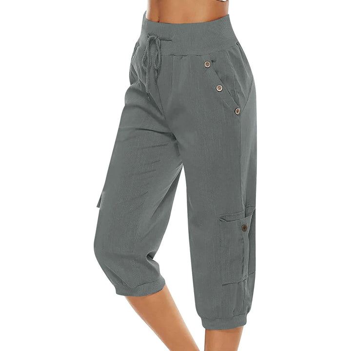"Kvinnors croppade byxor med elastisk midja, polyester, enfärgade, vadlånga, med fickor och dragsko."