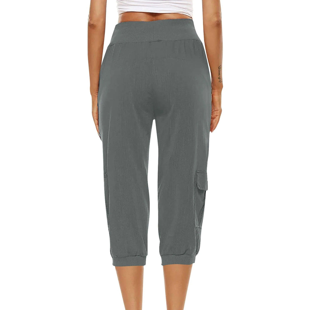 "Kvinnors croppade byxor med elastisk midja, polyester, enfärgade, vadlånga, med fickor och dragsko."