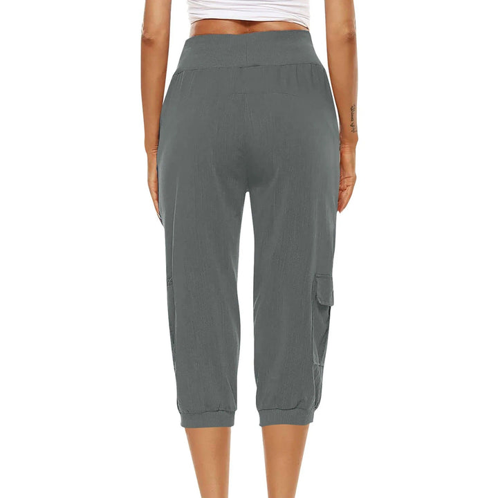 "Kvinnors croppade byxor med elastisk midja, polyester, enfärgade, vadlånga, med fickor och dragsko."
