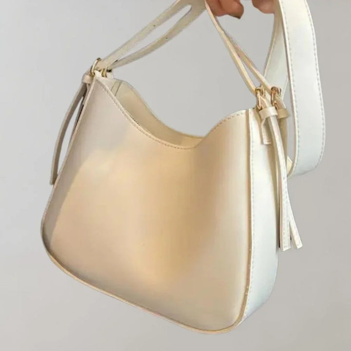 Dam Crossbody-väska med strukturerad design, guldaccenter, justerbar rem, elegant och funktionell för modern stil.
